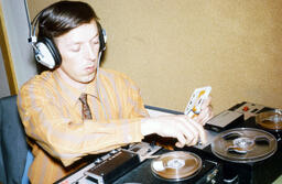 Student operating a reel to reel machine