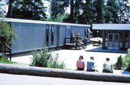 Students relax outside at Mathers Ave. campus
