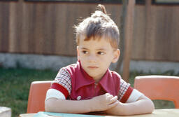 Child sits at table
