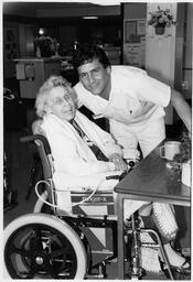 Male nurse with patient in wheelchair