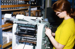 Student operating a mimeograph