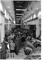 People milling about in hall at grad