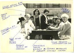 Multiple staff and faculty members at a picnic table