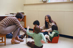 ECE student sits with children